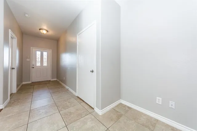 a kitchen with kitchen island granite countertop stainless steel appliances and a refrigerator