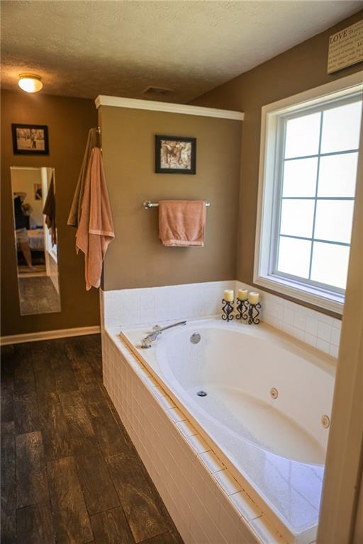 1665 Jackson Lake Road Mansfield, GA 30055 - Photo 14 of 16 a bathroom with a tub and a window