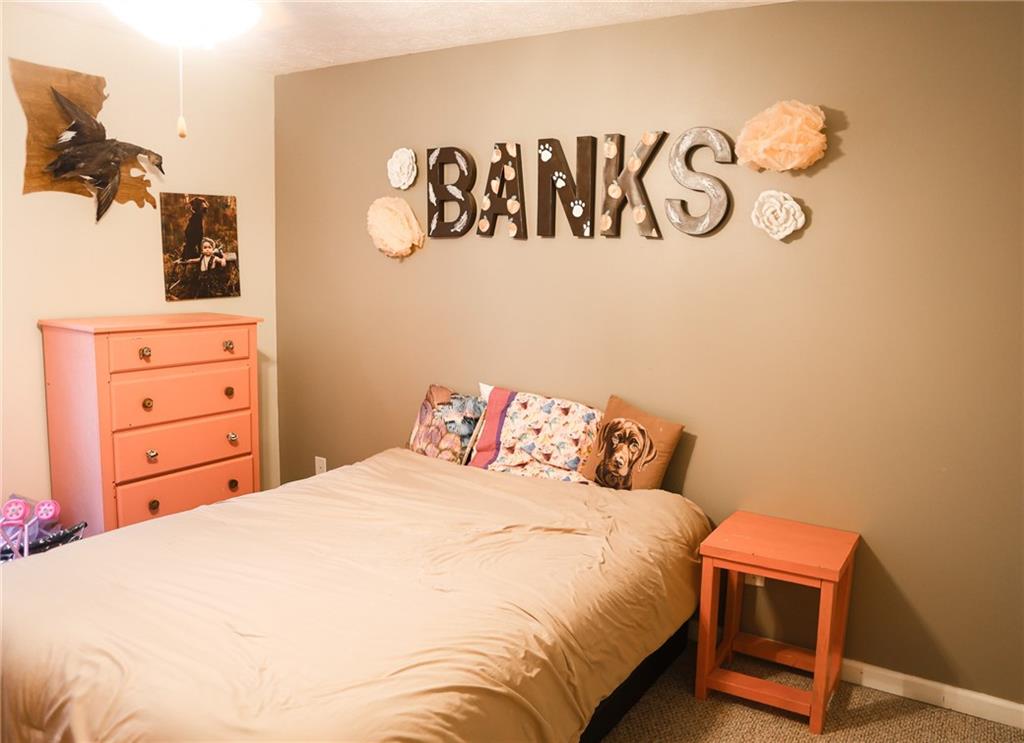 1665 Jackson Lake Road Mansfield, GA 30055 - Photo 15 of 16 a bedroom with a bed and a dresser
