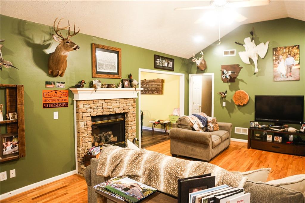 1665 Jackson Lake Road Mansfield, GA 30055 - Photo 4 of 16 a living room with furniture a flat screen tv and a fireplace