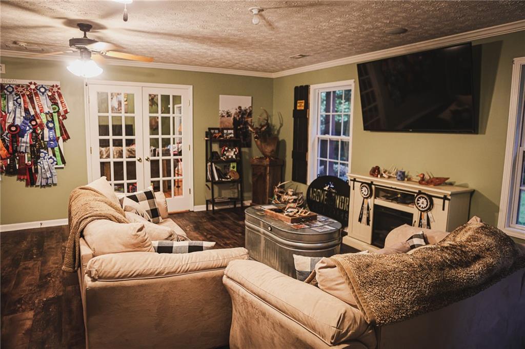 1665 Jackson Lake Road Mansfield, GA 30055 - Photo 6 of 16 a living room with furniture a flat screen tv and a window