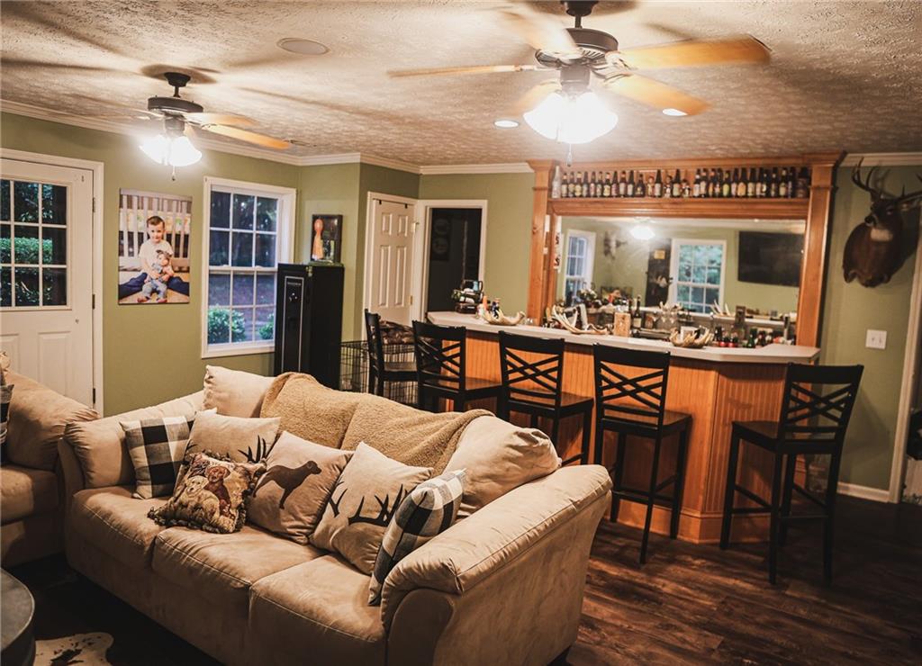 1665 Jackson Lake Road Mansfield, GA 30055 - Photo 7 of 16 a living room with furniture a ceiling fan and a rug