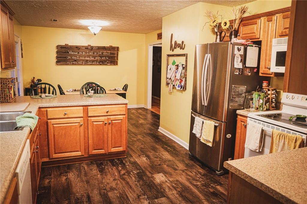 1665 Jackson Lake Road Mansfield, GA 30055 - Photo 10 of 16 a view of a kitchen with furniture and a refrigerator
