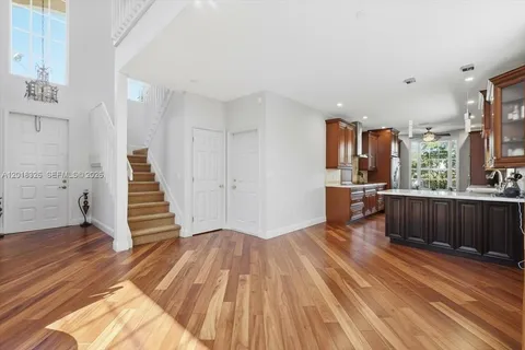 a view of a kitchen with wooden floor and electronic appliances