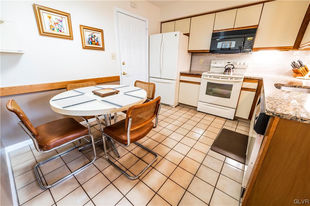 1201 Butztown Road, Unit 24 Bethlehem, PA 18017 - Photo 12 of 30 a kitchen with stainless steel appliances a stove refrigerator sink and table