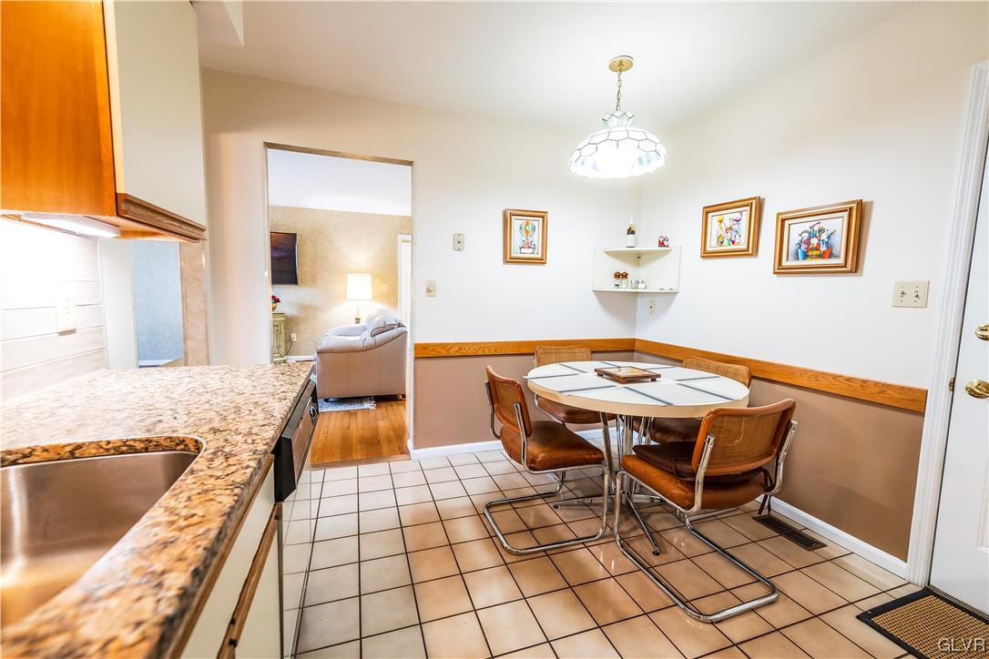 1201 Butztown Road, Unit 24 Bethlehem, PA 18017 - Photo 13 of 30 a dining hall with a dining table and chairs with wooden floor