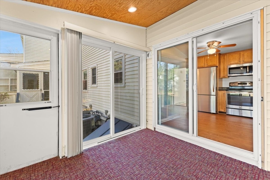 139 Burt Street, Unit 6 Norton, MA 02766 - Photo 21 of 31 a view of a hallway with wooden floor and a kitchen