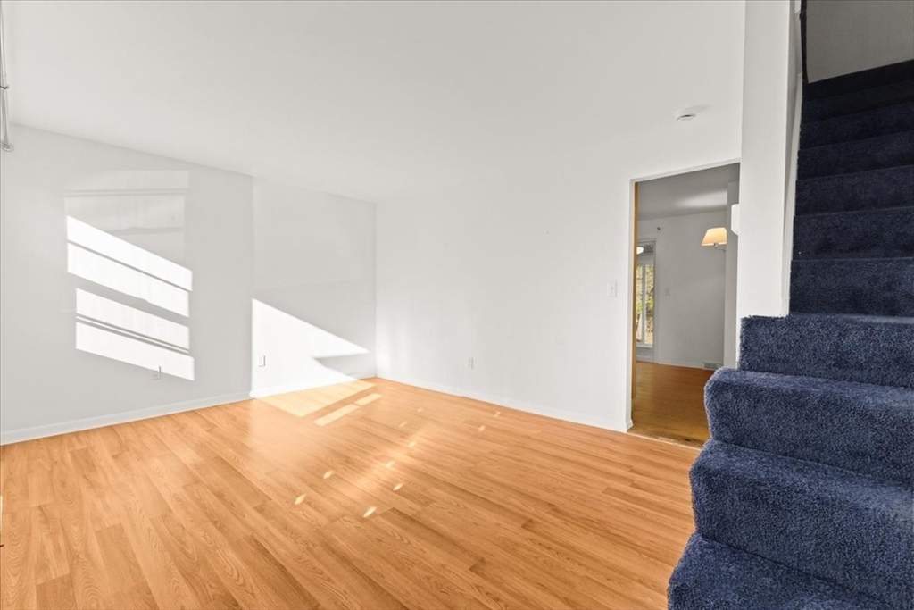 139 Burt Street, Unit 6 Norton, MA 02766 - Photo 7 of 31 a bedroom with a bed and wooden floor