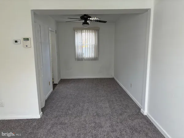 an empty room that has a window in it