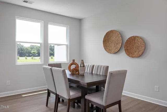 a view of a dining room with furniture window and wooden floor