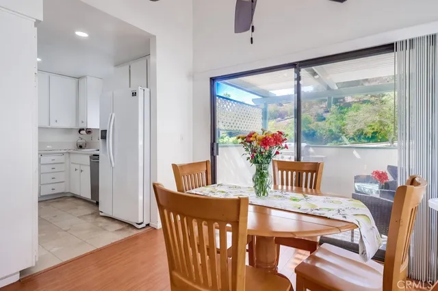 a dining room with furniture and a large window