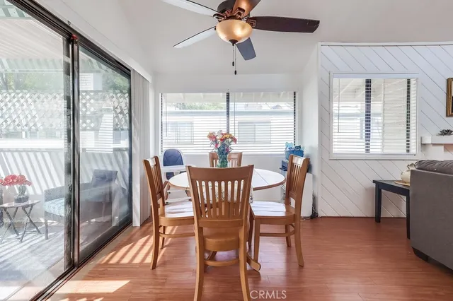 a dining room with furniture a chandelier and wooden floor
