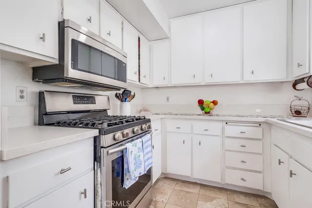a kitchen with cabinets appliances and a sink