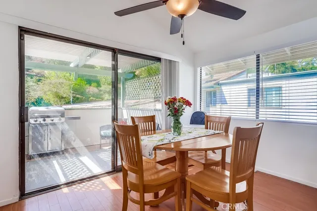 a dining room with furniture window and wooden floor