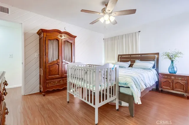 a bedroom with furniture and wooden floor