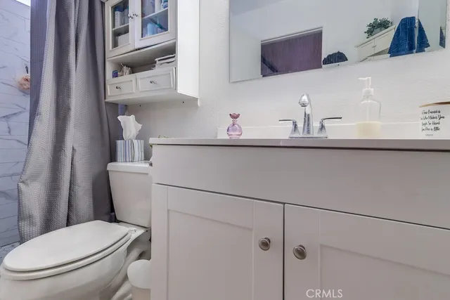 a white toilet sitting next to a bathroom sink