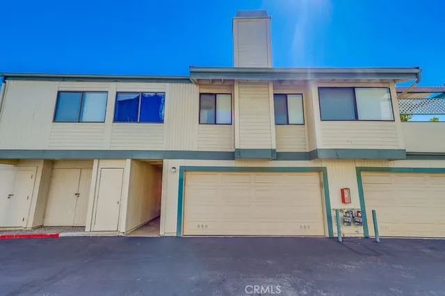 a view of a backyard with swimming pool and sitting area
