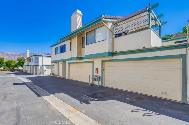 a view of a backyard with swimming pool