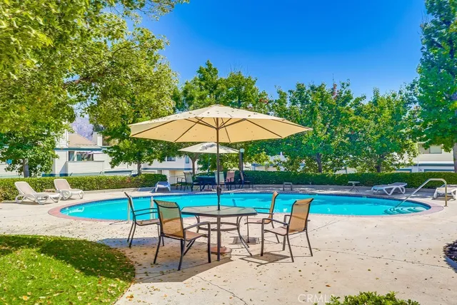 a view of a backyard with swimming pool