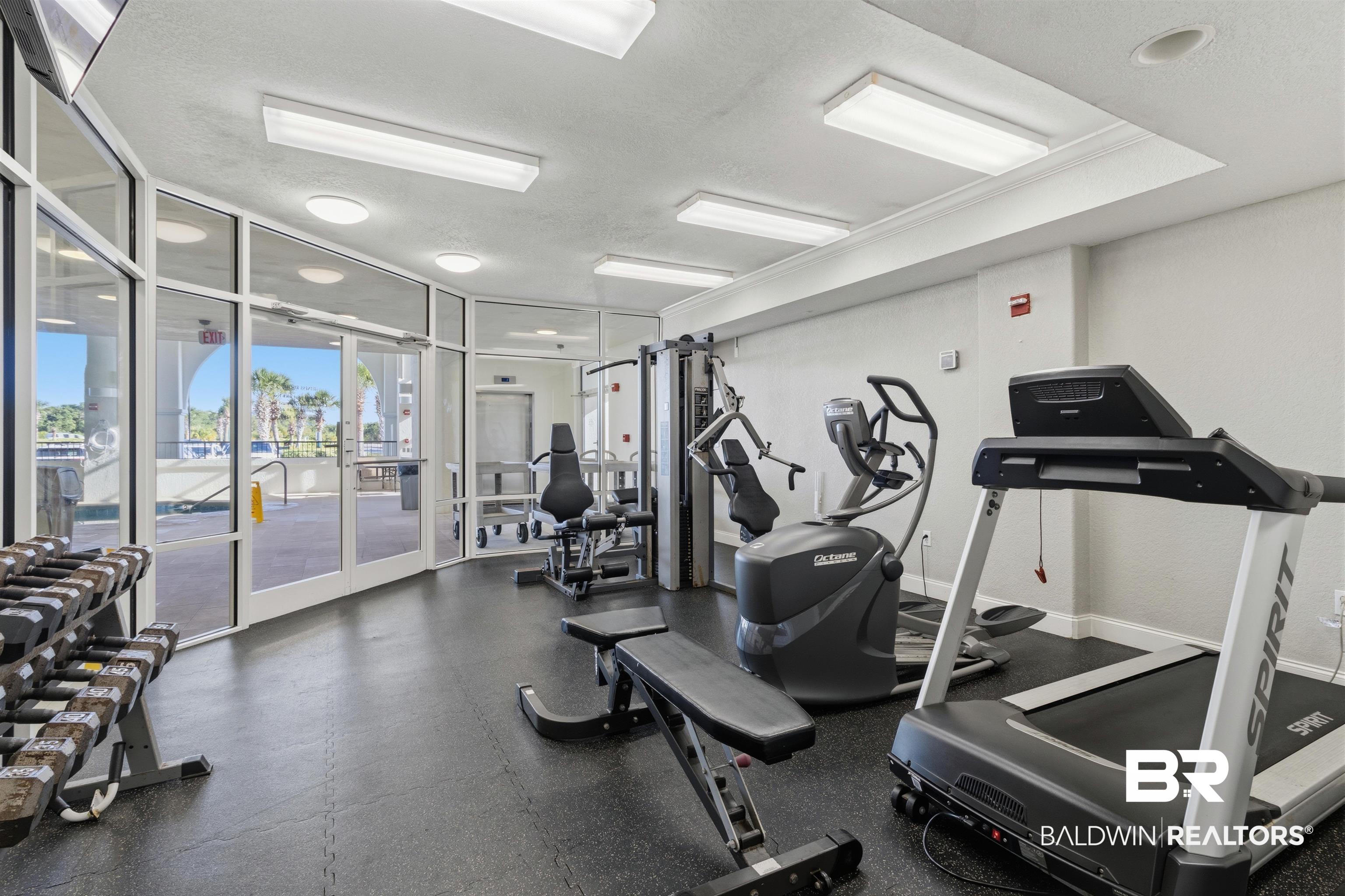3564 Bayou Road, Unit 203 Orange Beach, AL 36561 - Photo 31 of 53 Fitness center featuring floor-to-ceiling windows, rubber flooring, recessed lighting, and crown molding