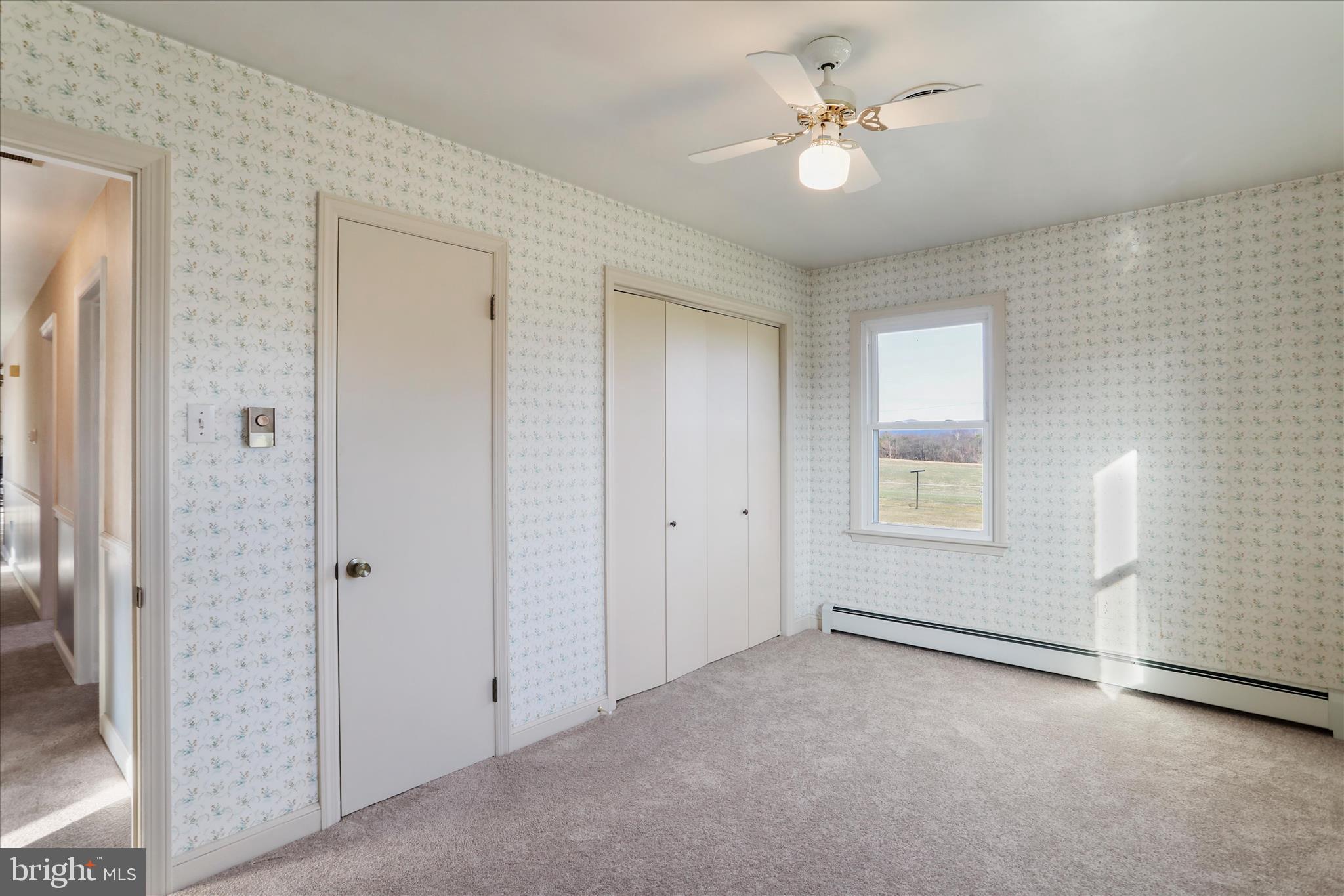 13728 Broadfording Church Road Hagerstown, MD 21740 - Photo 26 of 44 a view of a livingroom with a ceiling fan & window