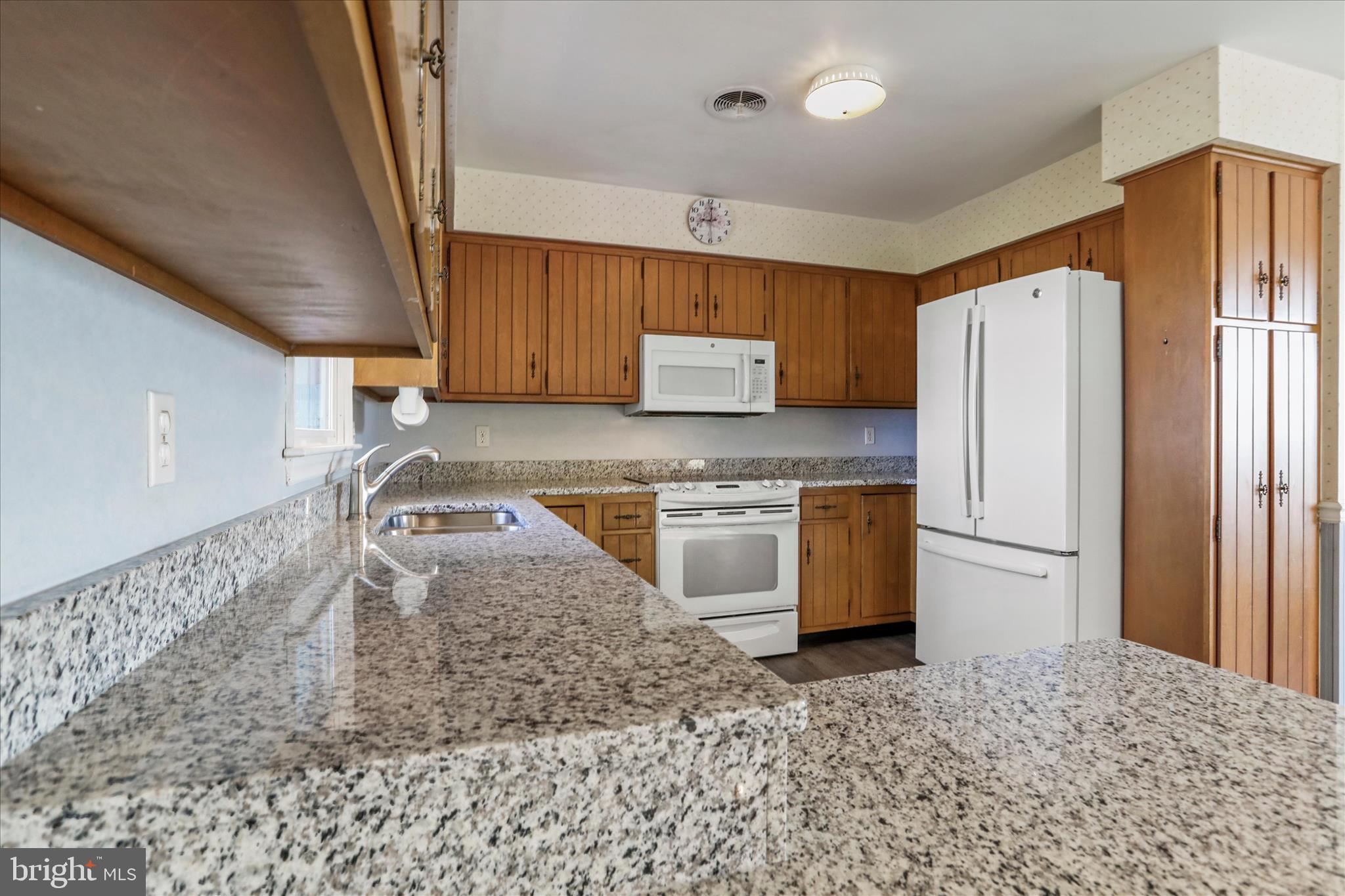 13728 Broadfording Church Road Hagerstown, MD 21740 - Photo 7 of 44 a kitchen with stainless steel appliances granite countertop a refrigerator a stove and a sink with granite countertops