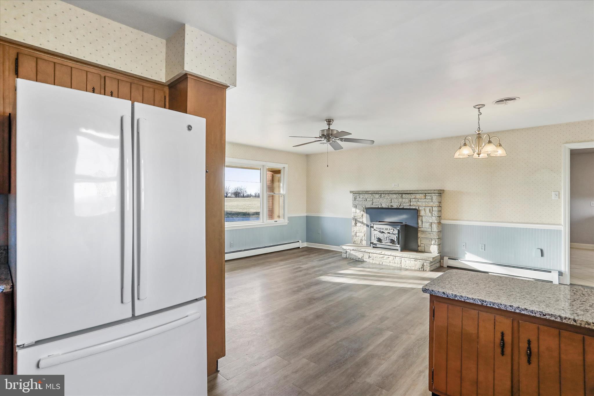 13728 Broadfording Church Road Hagerstown, MD 21740 - Photo 10 of 44 a view of a livingroom with a fireplace wooden floor and staircase