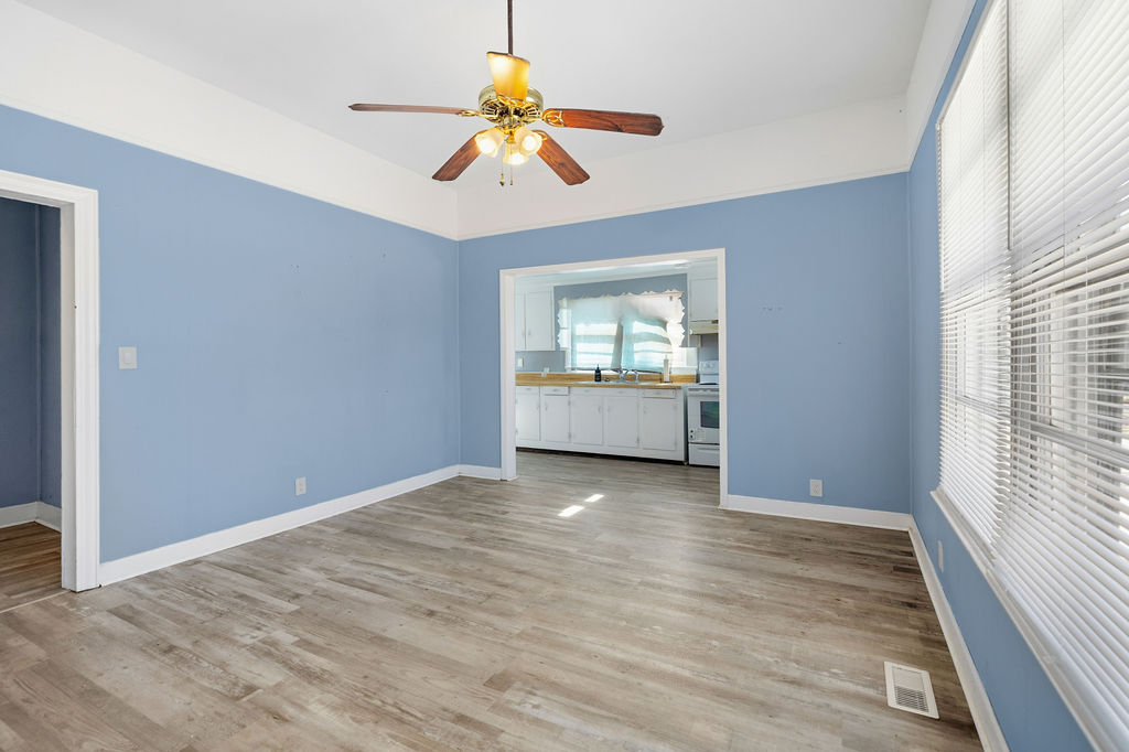 215 Louisiana Street Honea Path, SC 29654 - Photo 11 of 26 Bright and airy living area with seamless flow into the kitchen, creating an inviting space.