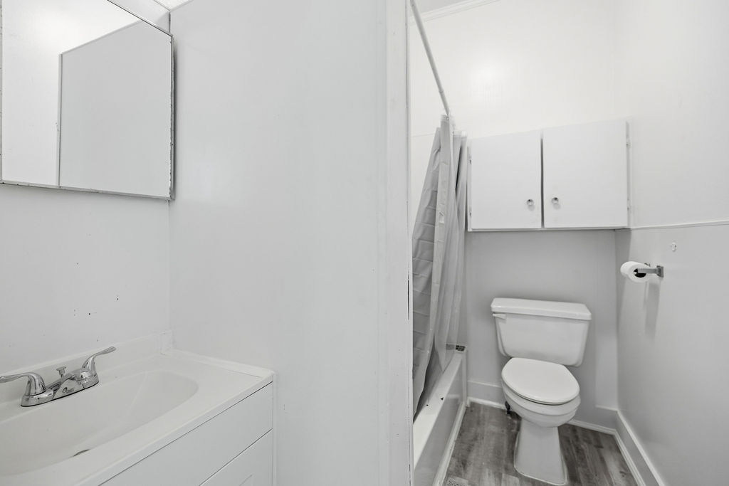 215 Louisiana Street Honea Path, SC 29654 - Photo 16 of 26 This clean and functional bathroom features a shower, toilet, and vanity with ample storage.