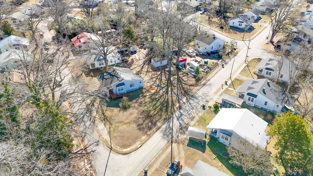 215 Louisiana Street Honea Path, SC 29654 - Photo 25 of 26 An aerial perspective showcases a vibrant neighborhood of charming homes with diverse roofing and expansive yards.