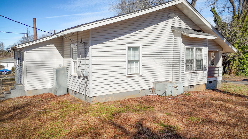 215 Louisiana Street Honea Path, SC 29654 - Photo 3 of 26 This charming home offers a quaint exterior with classic siding and a welcoming porch.