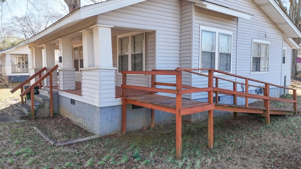 215 Louisiana Street Honea Path, SC 29654 - Photo 4 of 26 This inviting home features a charming front porch, ideal for enjoying peaceful moments.