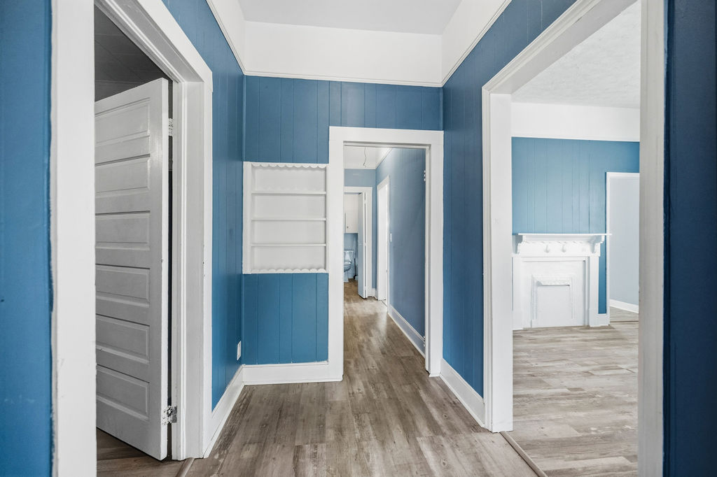 215 Louisiana Street Honea Path, SC 29654 - Photo 6 of 26 This interior hallway features beautiful flooring and bright walls, connecting various rooms within the home.