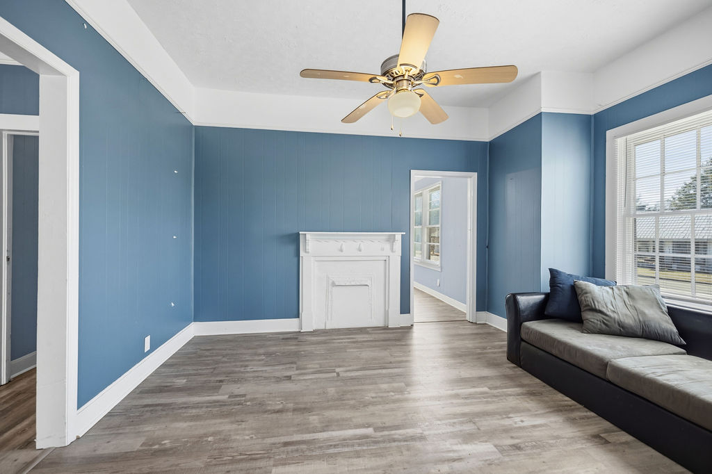 215 Louisiana Street Honea Path, SC 29654 - Photo 9 of 26 This inviting space features a charming fireplace and durable flooring, perfect for relaxation and everyday living.