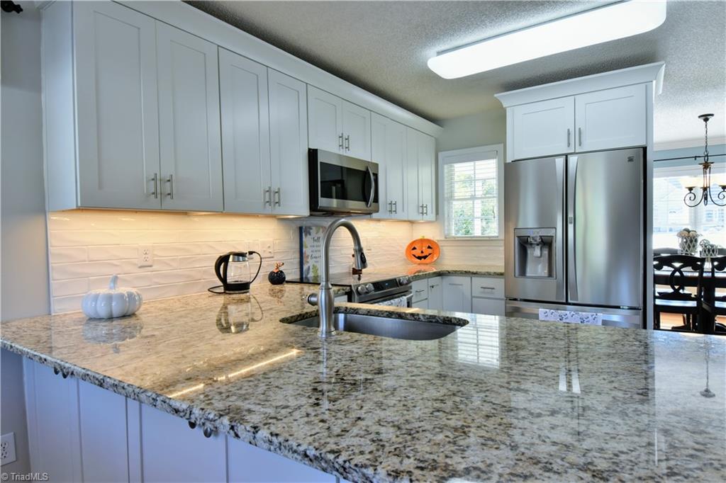 111 Montclair Drive Advance, NC 27006 - Photo 18 of 44 kitchen with granite countertops, nice lighting