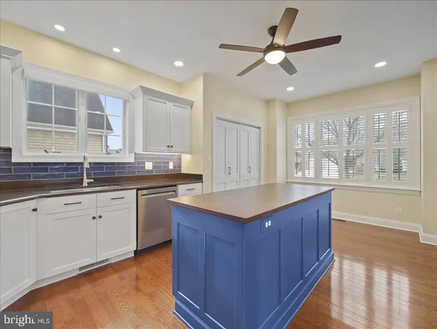 a kitchen with granite countertop cabinets stainless steel appliances a sink and a large window