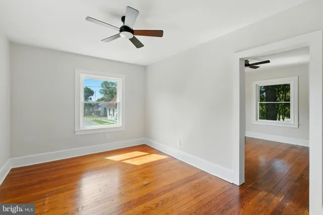 wooden floor in an empty room with a window