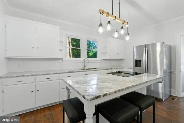a kitchen with a sink a stove a refrigerator and cabinets