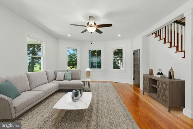 a living room with furniture and a wooden floor