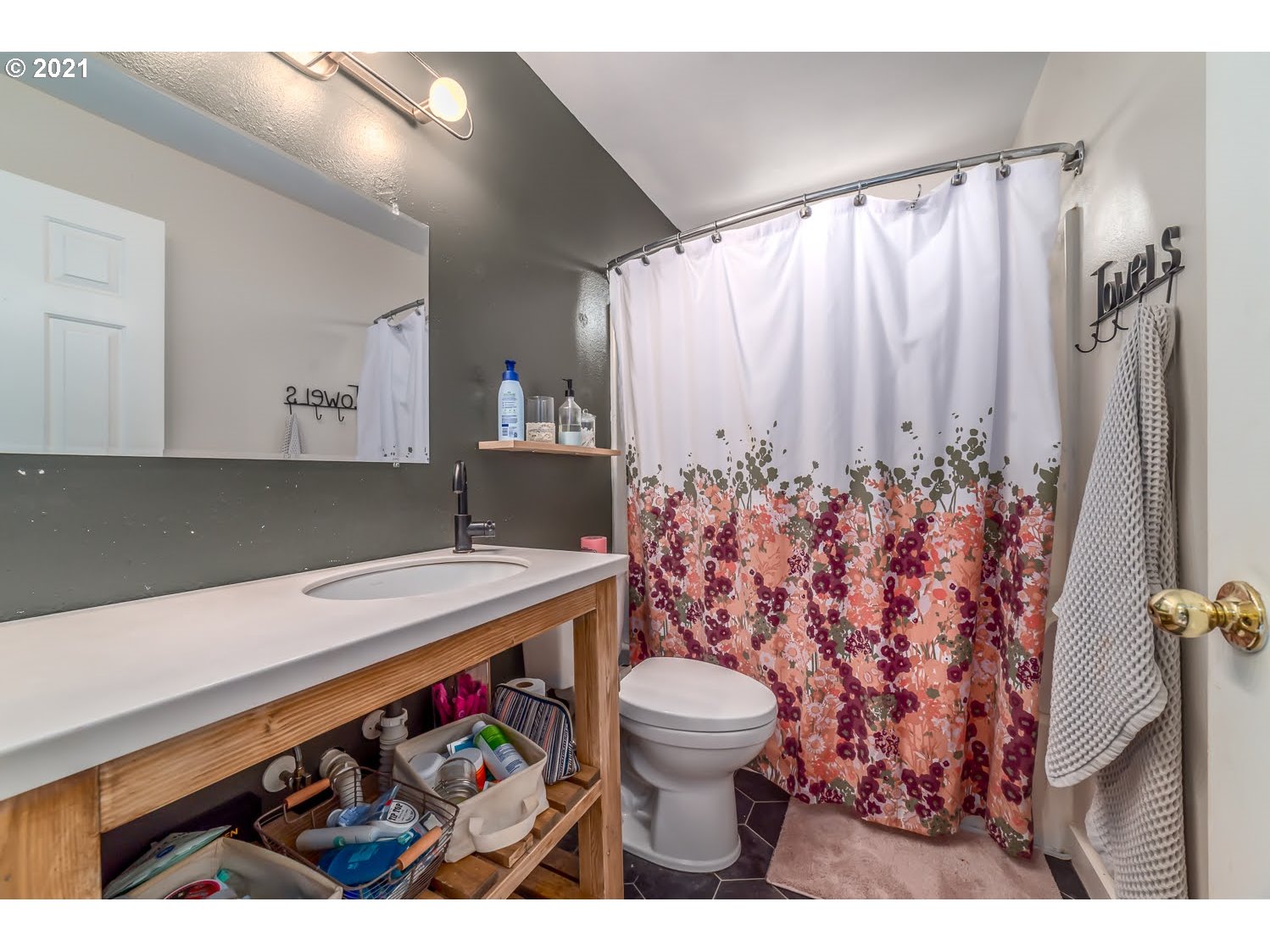 238 South 68th Court Springfield, OR 97478 - Photo 14 of 31 a bathroom with a sink a toilet and shower curtain