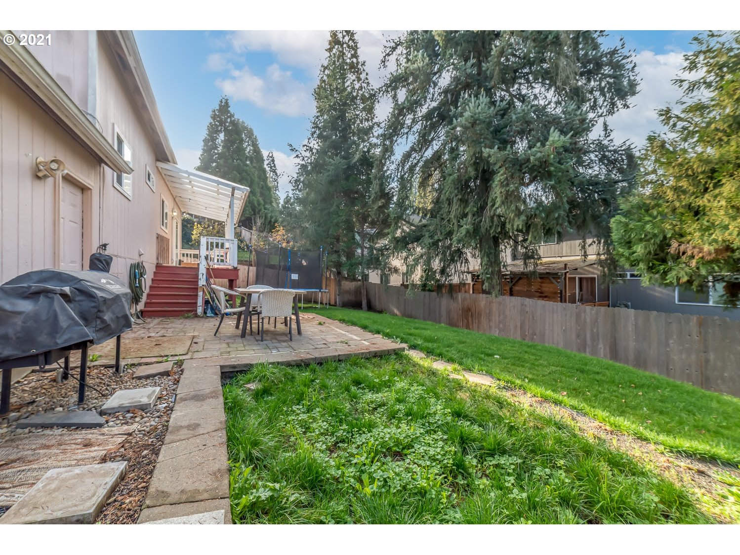 238 South 68th Court Springfield, OR 97478 - Photo 30 of 31 a view of a patio with table and chairs potted plants and large tree