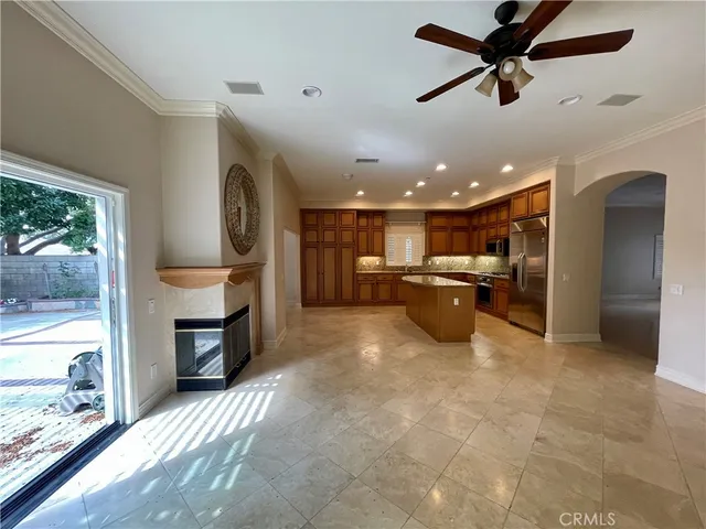 a open kitchen with a refrigerator a oven a sink and a large window