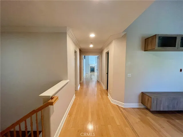 a view of entryway and hall with wooden floor