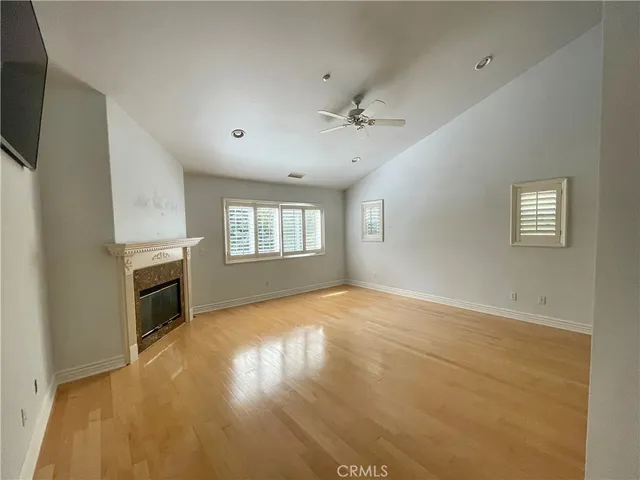a view of an empty room with a fireplace and a window