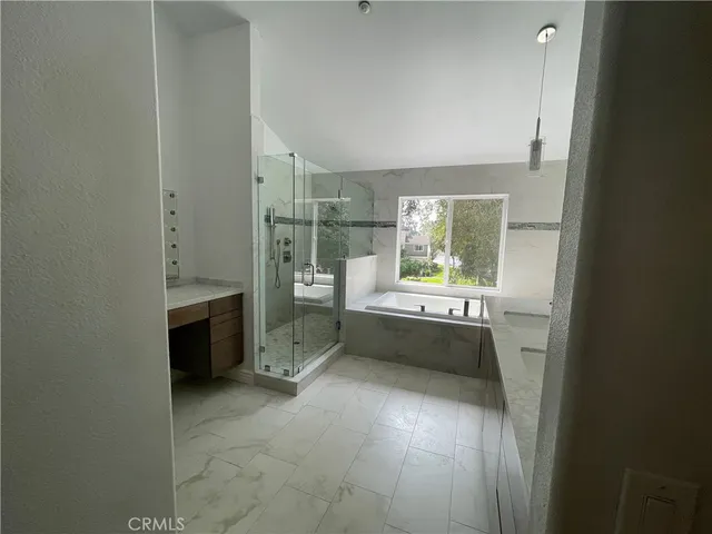 a bathroom with a tub sink and mirror