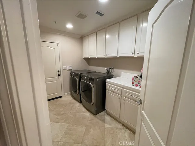 a bathroom with a glass door shower and a sink