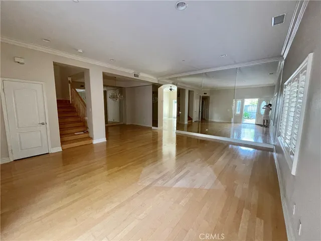 wooden floor in a hall with an entryway of a house