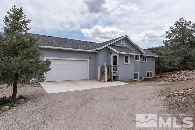 21881 Clemens Road Reno, NV 89521 - Photo 1 of 1 a front view of a house with a yard and garage