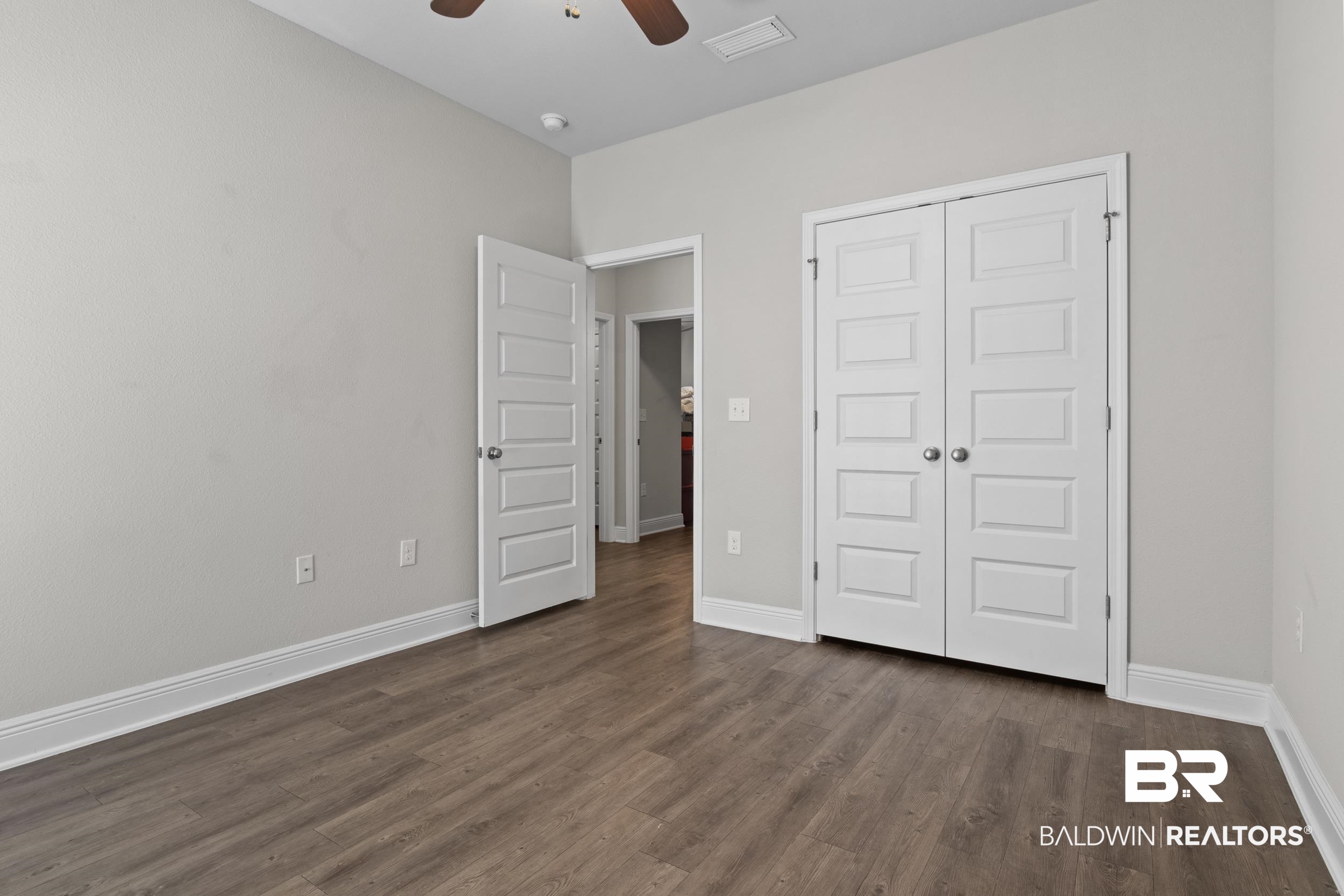 2050 Bourbon Street Foley, AL 36535 - Photo 27 of 32 Unfurnished bedroom with ceiling fan, a closet, and dark hardwood / wood-style floors