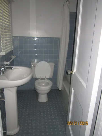 a white toilet sitting next to a white sink